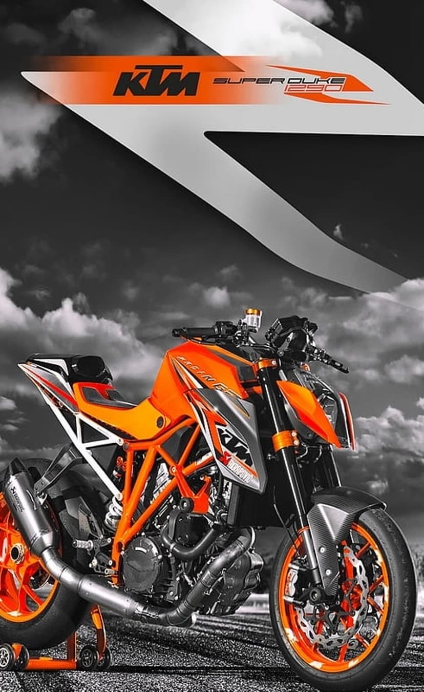 KTM Super Duke 250 motorcycle with orange accents on a paddock stand against a dramatic black and white cloudy sky.