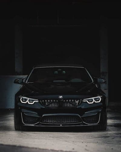 Stealthy BMW M4 Coupe Front View Mobile Background