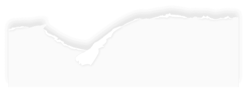 Torn paper scrap with jagged angled edges displays a high-contrast black and white rough texture on a background.
