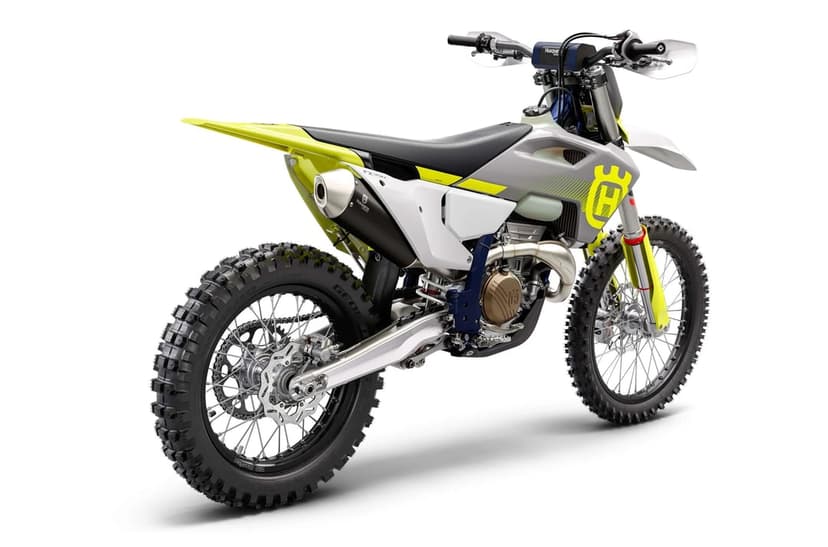 Husqvarna FX 350 dirt bike with yellow accents and knobby tires angled on a white studio background.