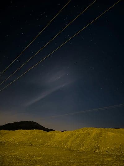 Midnight Galaxy Sky Above Silhouetted Ridges Phone Wallpaper