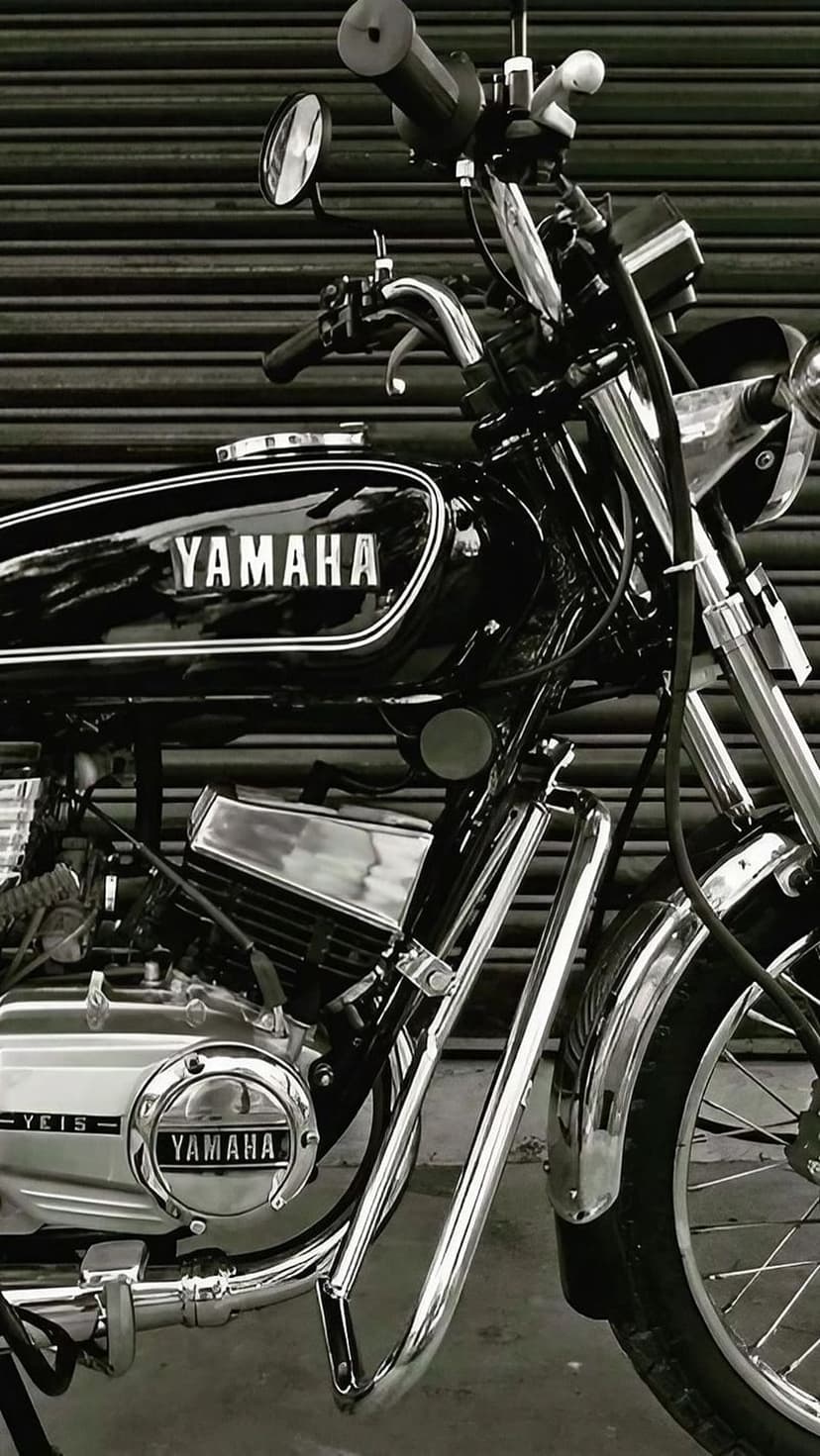 Yamaha motorcycle engine and fuel tank shown in a black and white close-up with polished chrome accents.