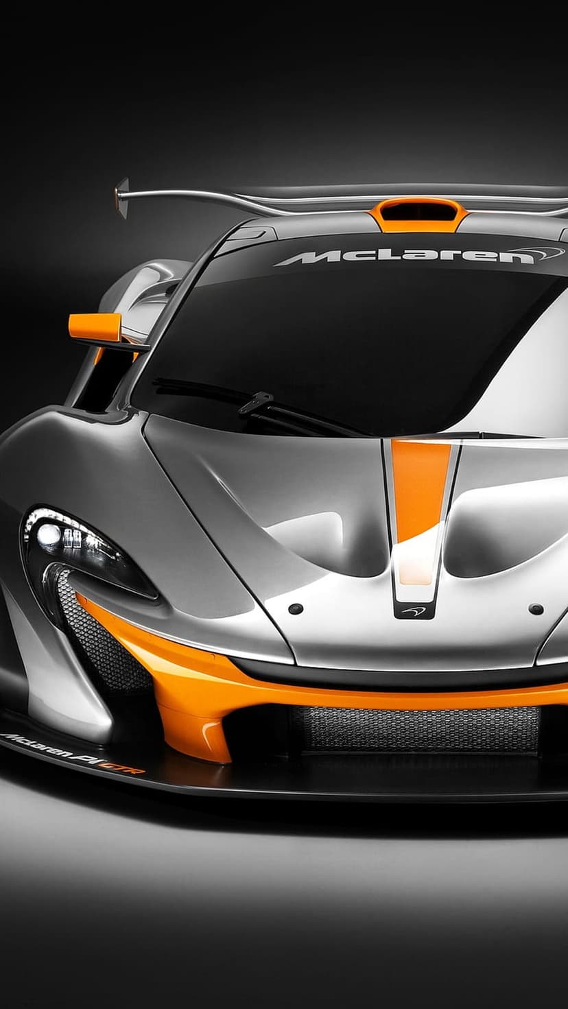 McLaren P1 GTR supercar with silver paint and orange racing stripes viewed from the front at close range.