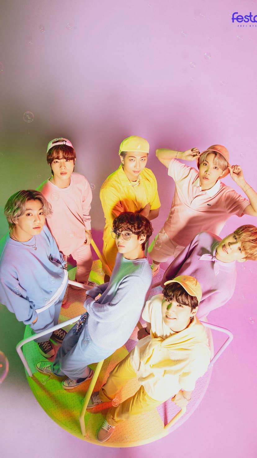 Seven BTS members in pastel suits pose playfully for a vibrant Butter era concept photo for mobile backgrounds.