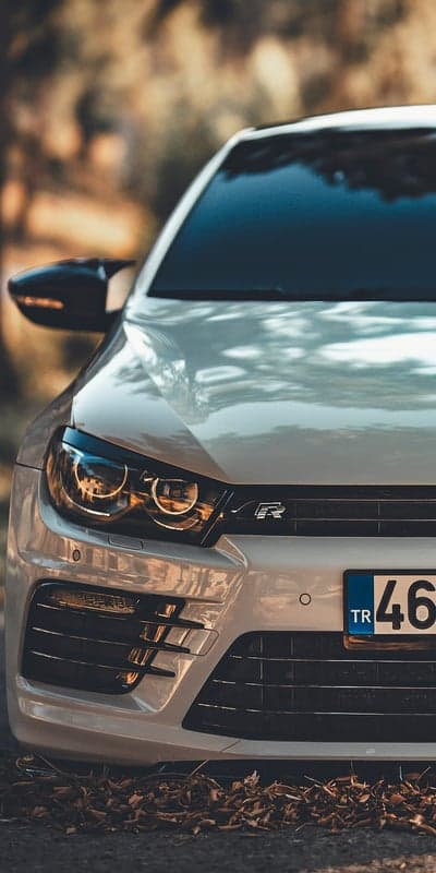 Close-up of White VW Scirocco R headlights and grille
