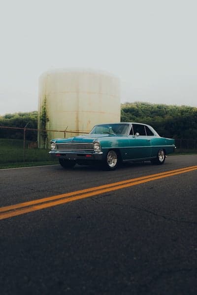Vintage Teal Classic Car by Industrial Tank