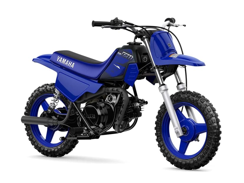Blue Yamaha PW50 dirt bike with knobby tires and matching blue rims against a solid white background.