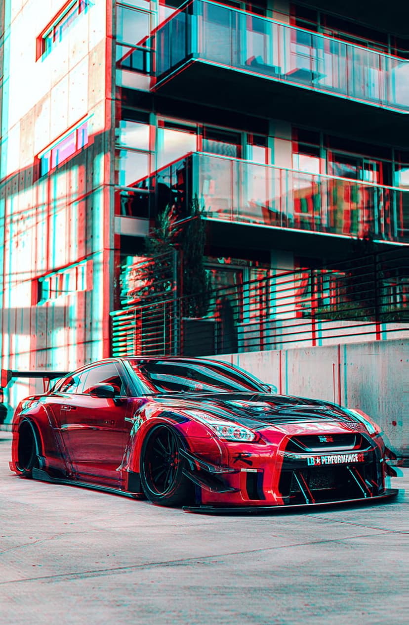 Red Nissan GT-R with a widebody kit parked near a modern building features a 3D red-cyan anaglyph effect.
