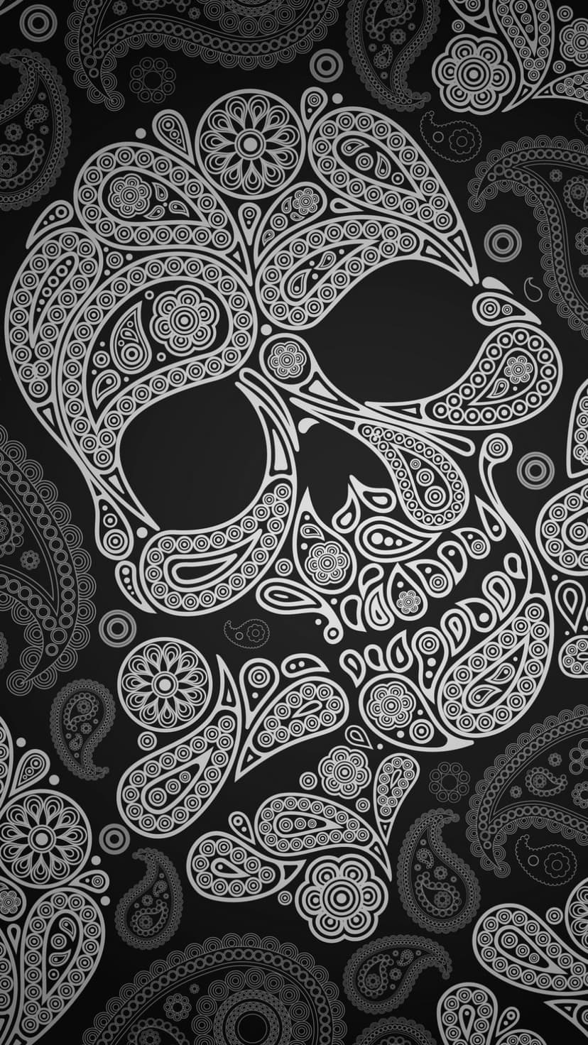 Human skull silhouette composed of intricate white paisley swirls and floral patterns on a solid black background.