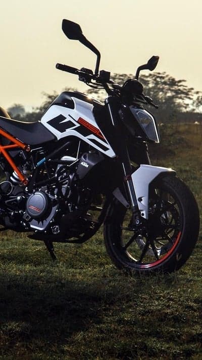 KTM Duke motorcycle parked on grass field