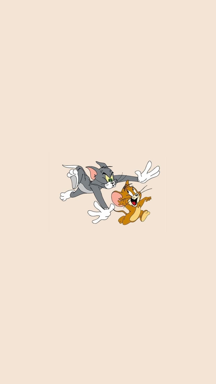 Tom the grey cat lunges with outstretched paws toward Jerry the mouse running ahead with a cheeky smile.