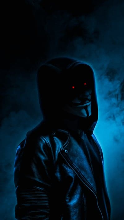 Anonymous Hacker in Dark Hoodie with Red Eyes