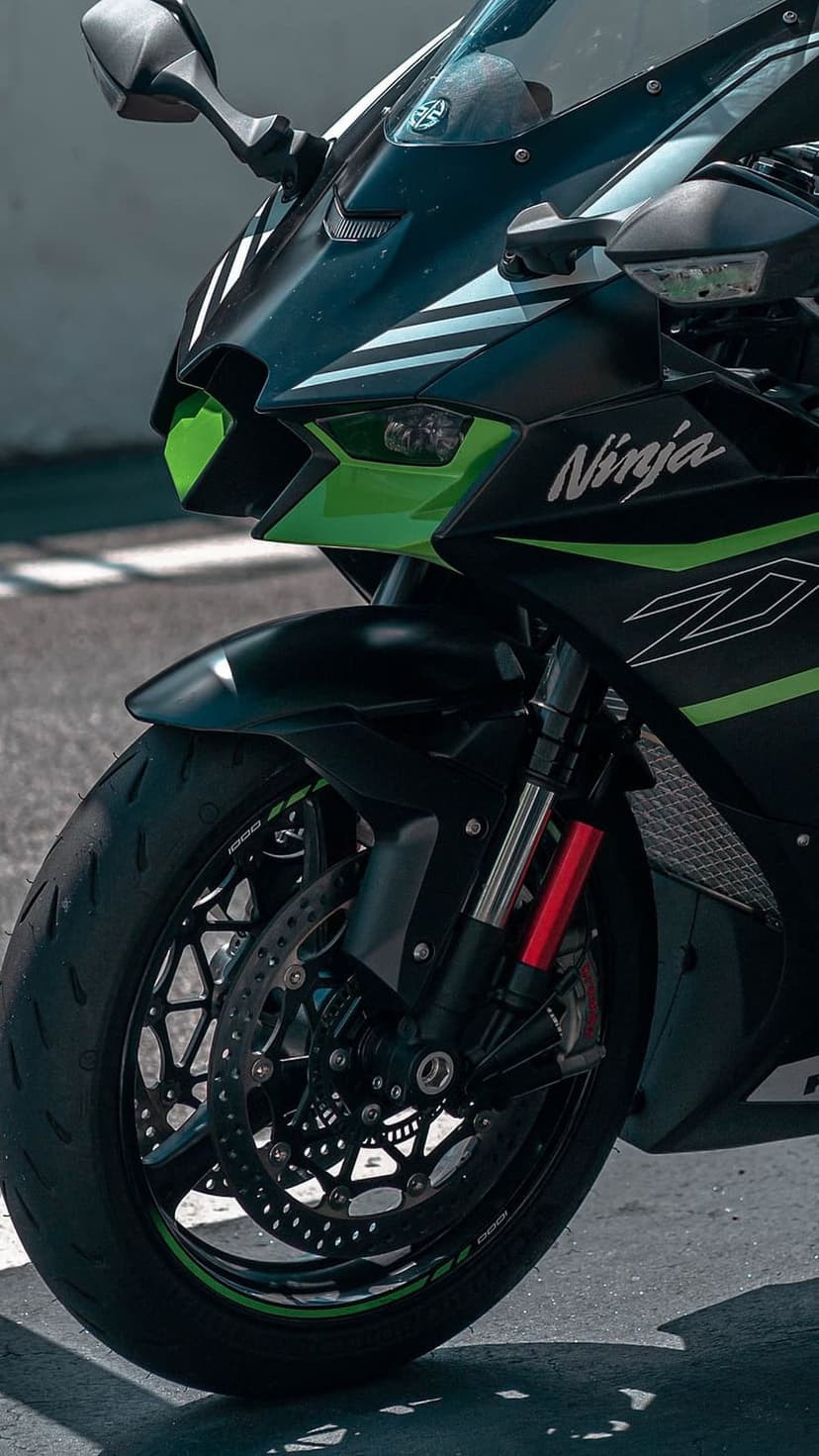 Kawasaki Ninja H2R motorcycle front view featuring green trellis frame, dual headlights, and carbon fiber winglets.
