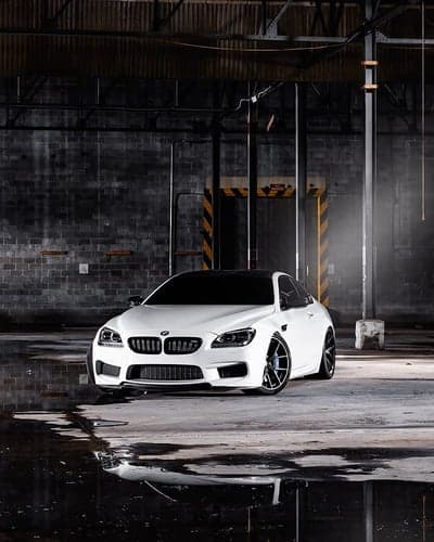 White BMW M6 Coupe Gleaming in Industrial Garage