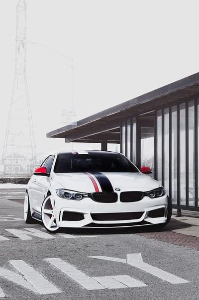 Sporty White BMW M4 with Racing Stripes Mobile Wallpaper