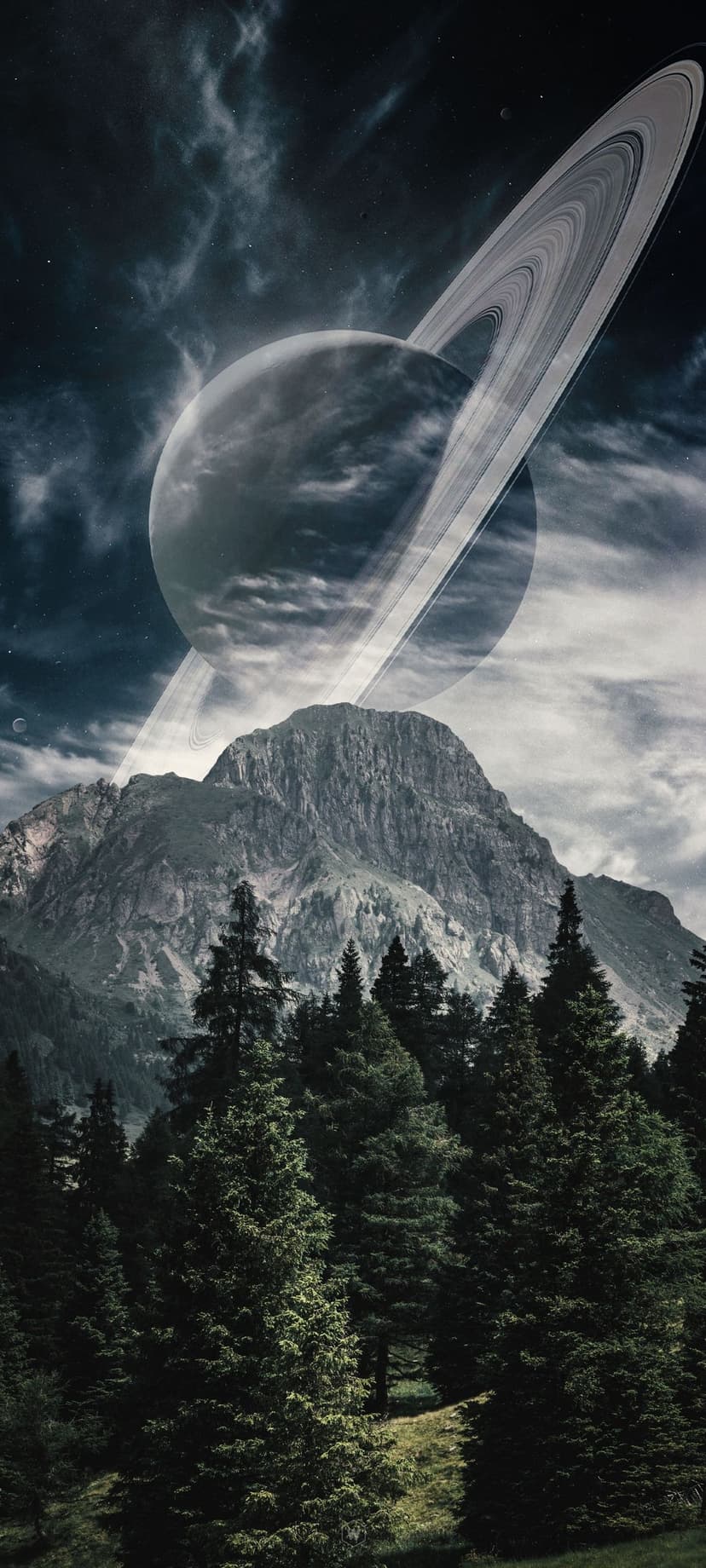 Saturn with glowing rings rises behind sharp mountain peaks and a dense evergreen forest under a cloudy sky.