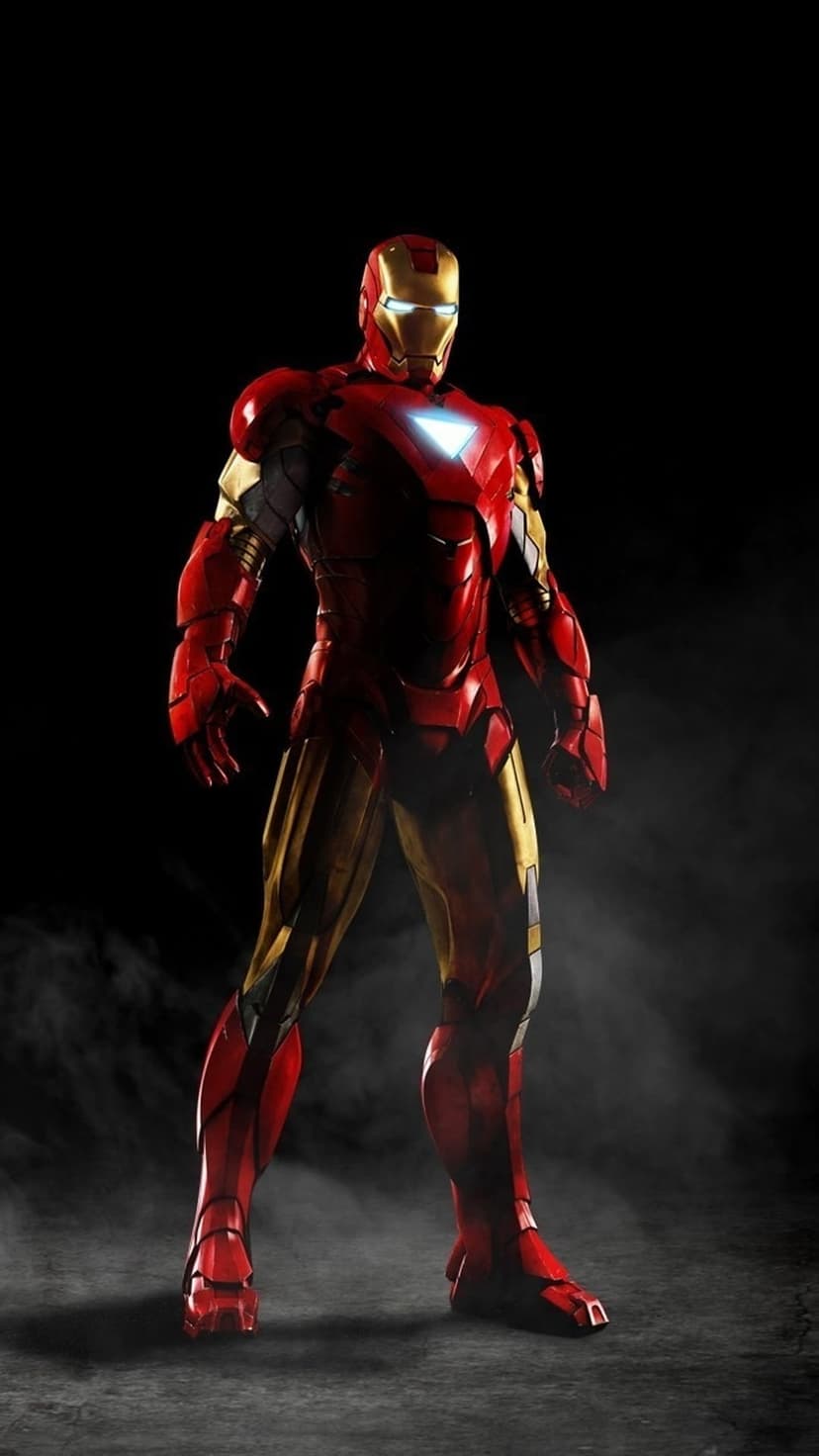 Iron Man in red and gold armor with a glowing white arc reactor stands against a dark smoky background.