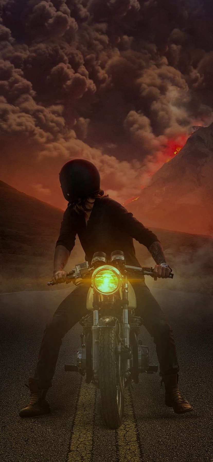Motorcyclist in black gear rides toward a massive volcanic eruption with red skies and flowing lava.