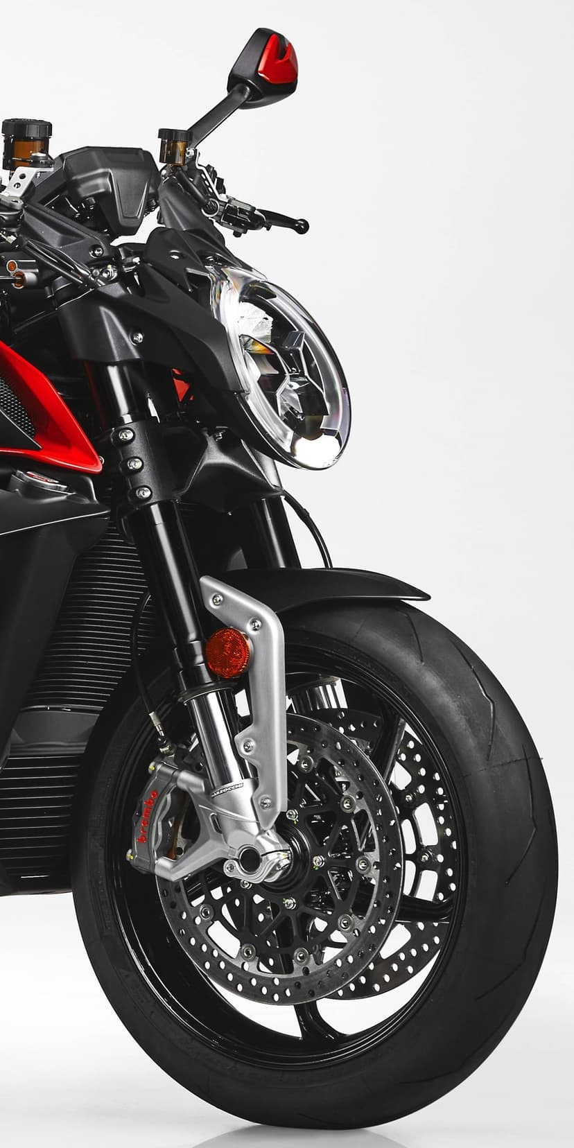 Close-up of a black motorcycle front wheel with red Brembo brakes, inverted forks, and a sleek oval LED headlight.