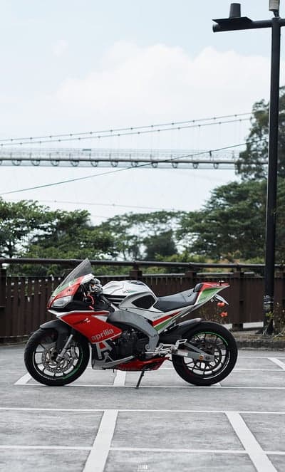 Aprilia Sportbike Near Suspension Bridge Mobile Wallpaper