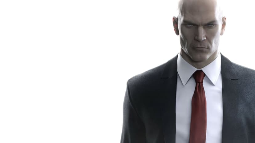 Agent 47 wearing a black suit and red tie against a white background with an intense, serious expression.