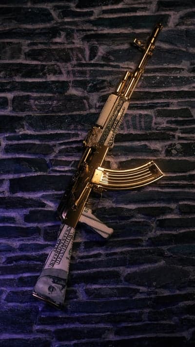 Gold AK-47 adorned with US dollar bills