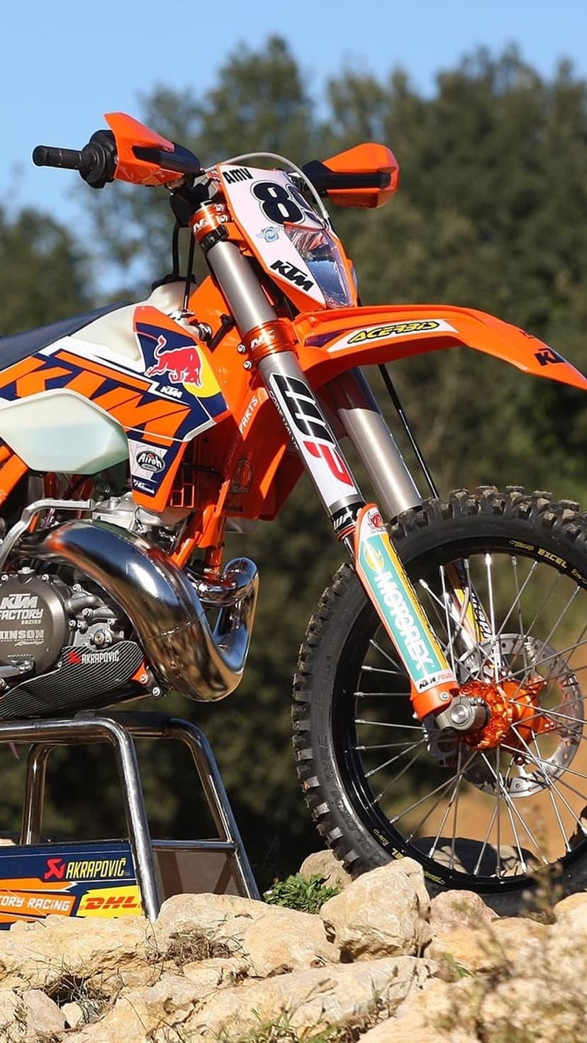 KTM dirt bike showcases a powerful engine and orange racing graphics in a high-detail mechanical close-up.