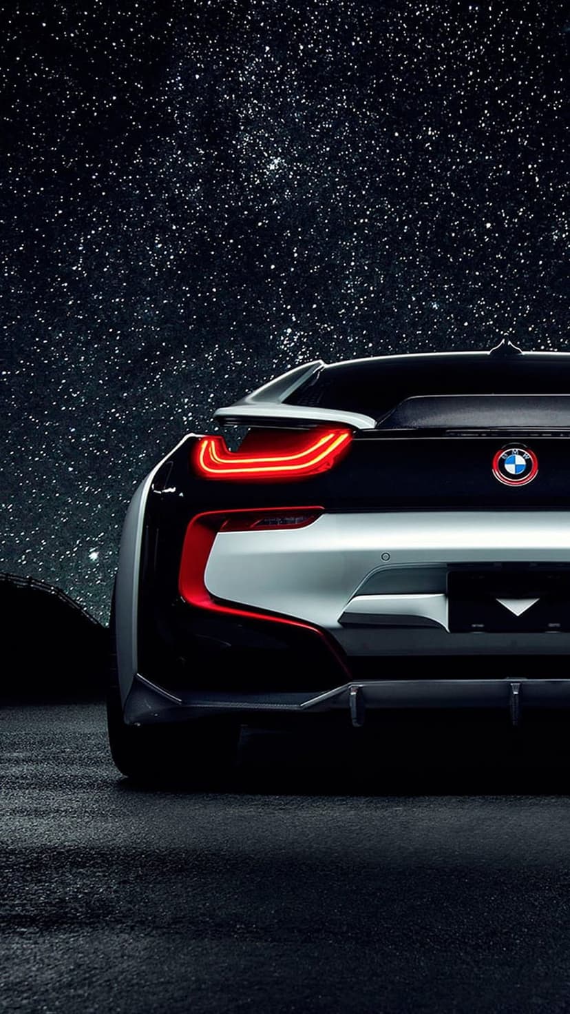 BMW i8 rear taillights glowing red beneath a dense field of twinkling stars and dark blue cosmic nebulas.