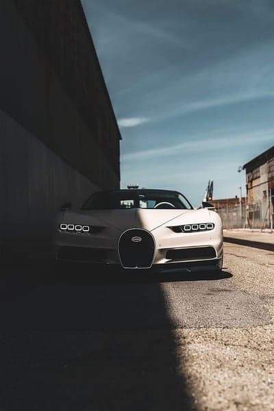 Bugatti Chiron parked in industrial alley with dramatic lighting