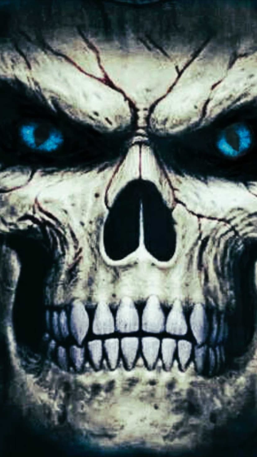 Weathered skull with deep cracks, glowing blue eyes, and sharp teeth set against a dark, atmospheric backdrop.