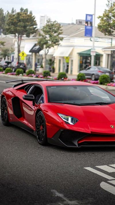 Red Lamborghini Aventador Driving Down Suburban Street
