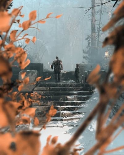 Two figures ascend snow-covered stone stairs in a misty forest