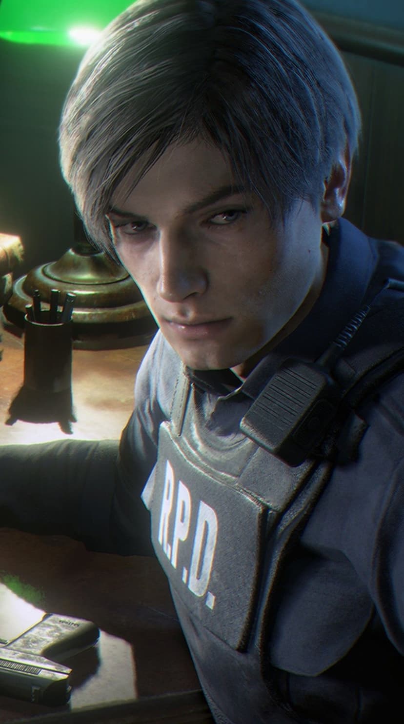 Leon Kennedy in RPD tactical gear sits at a desk under a green lamp with a handgun in a dark room.