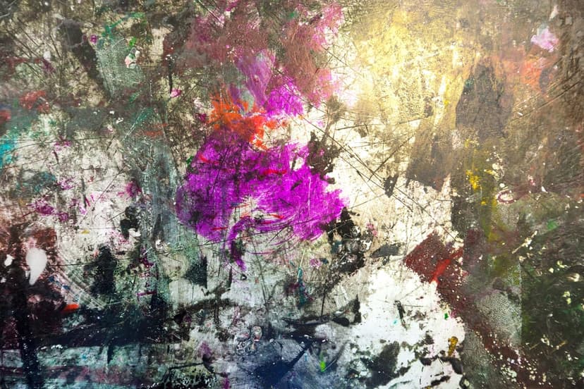 Purple and pink paint splatters mix with green smears on a heavily textured, glossy white and grey surface.