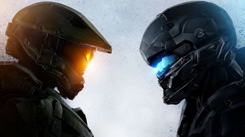 Master Chief in green armor faces Spartan Locke in black armor with glowing orange and blue visors.