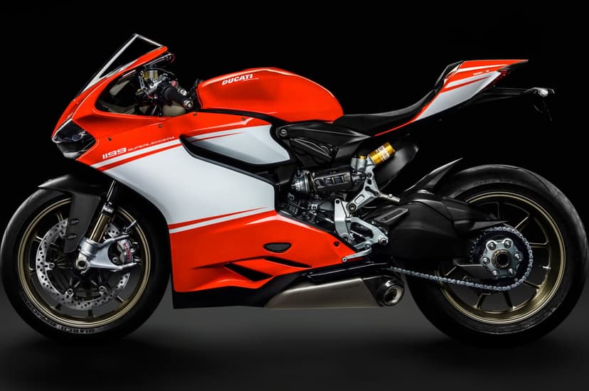 Red and white Ducati 1199 Superleggera motorcycle profile with gold wheels on a dark studio background.
