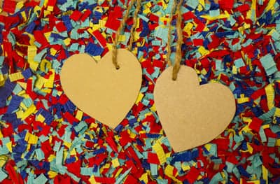 Two Heart-Shaped Tags on Colorful Confetti