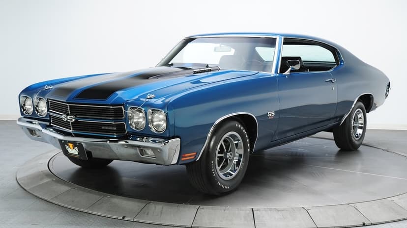 Blue 1970 Chevrolet Chevelle SS muscle car with black hood stripes and chrome bumpers in a white studio.