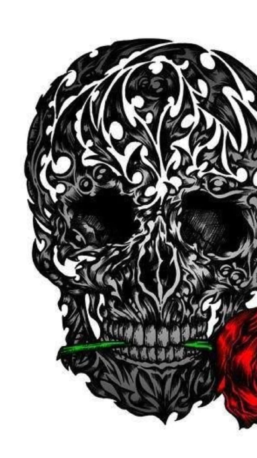 Ornate skull engraved with floral patterns holds a vibrant red rose in its teeth against a dark background.