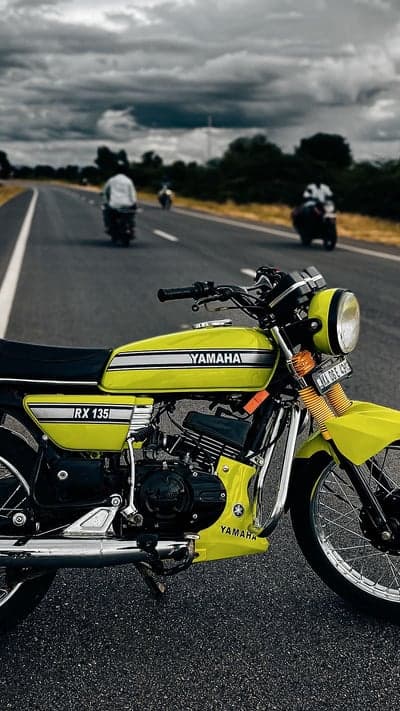 Classic Yamaha RX 135 motorcycle on asphalt road