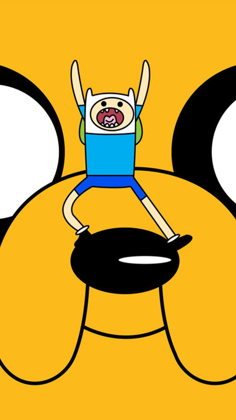 Finn the Human raises his arms in excitement above the oversized, smiling yellow face of Jake the Dog.