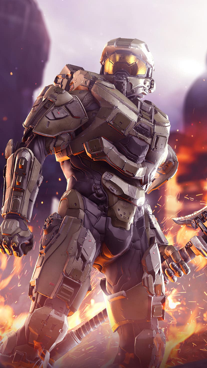 Master Chief in green MJOLNIR armor stands in front of fire and sparks with a glowing golden visor.
