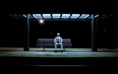 Man in Clown Makeup Waits at Bus Stop at Night