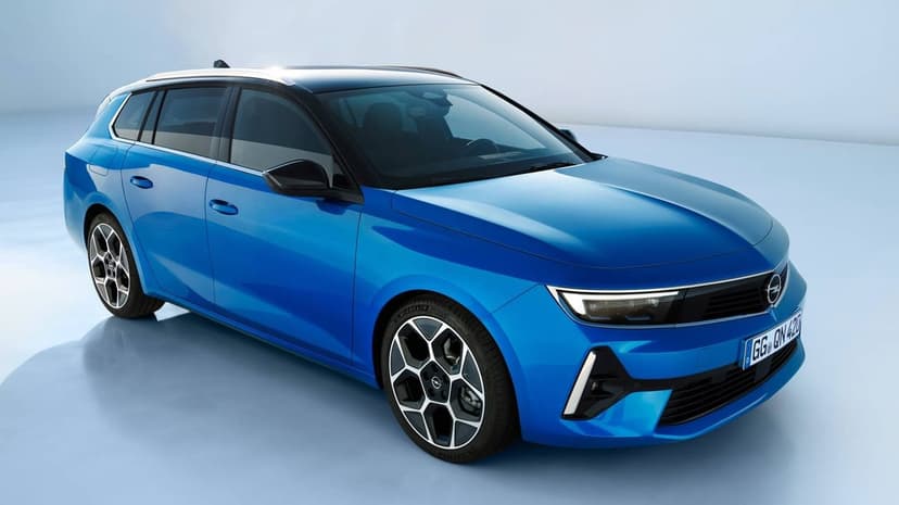 Blue Opel Astra Sports Tourer estate car with black roof and geometric wheels in a bright studio.