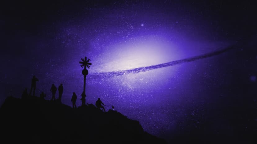 Silhouetted figures stand by a summit cross on a rocky peak under a swirling purple galaxy and bright stars.