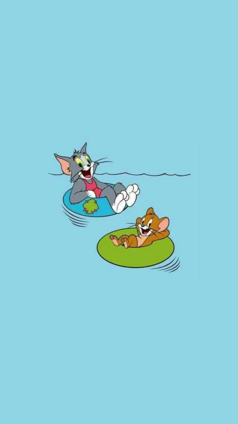 Tom and Jerry float on blue and green inner tubes in a swimming pool as Tom wears a bright pink swimsuit.
