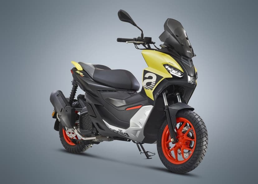 Aprilia SR GT scooter with lime yellow fairings and red wheels set against a clean gray studio background.