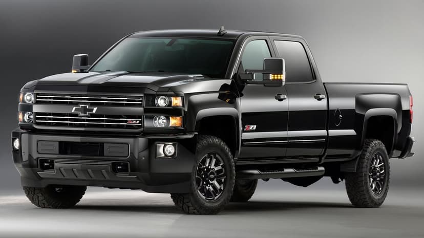 Black Chevrolet Silverado Z71 HD pickup truck with off-road tires against a grey studio background.