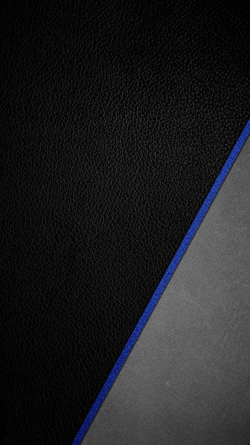 Electric blue diagonal stripe dividing a matte black textured surface from a gritty grey stone-like background.