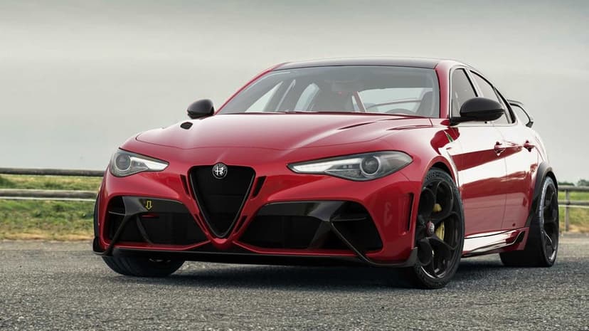 Red Alfa Romeo Giulia GTAm sports sedan with carbon fiber trim parked on asphalt under a cloudy sky.